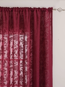 Detail of burgundy lace curtain with floral rose patterns and rod pocket header