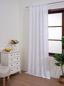 Close-up of white lace curtain featuring floral jacquard and rod pocket header