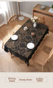Close-up of vintage black lace tablecloth with damascus patterns and tassel edges