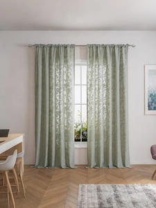 Close-up of sage green lace curtain with vintage floral jacquard and sheer texture