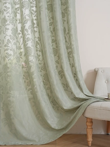 Detailed sage green floral jacquard curtain draped over a vintage French style chair