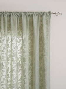 Detail of light green floral jacquard lace curtain with elegant rod pocket design