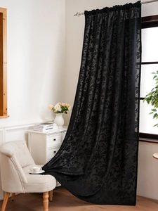 Detailed texture of black lace curtain with elegant floral embroidery and rod pocket top