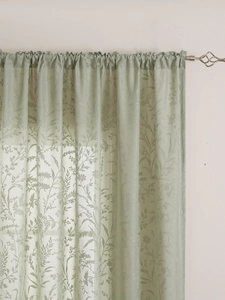 Close-up of sage green semi-transparent lace curtain with floral patterns and textures