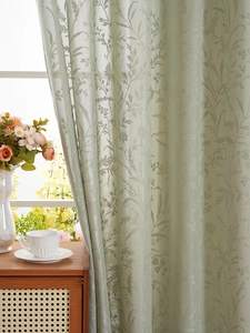 Detail of pea green lace curtain with elegant floral jacquard leaf patterns