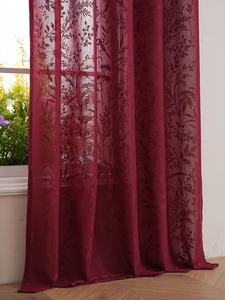 Detail of dark red semi-transparent lace curtain with elegant plant leaf pattern texture