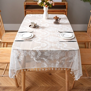 French style white lace tablecloth with floral patterns and tassels on a dining table