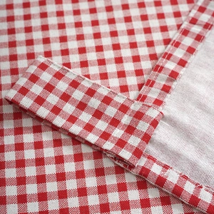 Close-up of red and white gingham cotton linen fabric showing stitching and texture