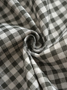 Macro view of black and white checkered cotton linen fabric with woven texture detail