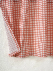 Detail of orange and white gingham cotton linen fabric with thick woven texture for curtains