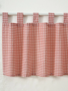 Detail of orange and white gingham cafe curtain with durable tab top hanging loops