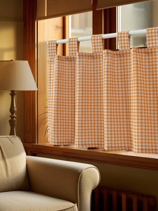 Detail of orange gingham tab top cafe curtain in thickened cotton linen for kitchen decor