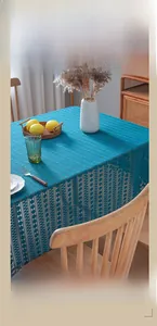 Close-up of deep lake blue lace tablecloth with elegant openwork patterns on a wooden table
