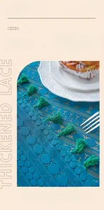 Detail of blue thickened lace tablecloth with elegant tassels and knit texture