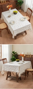 Detailed view of candy embroidery and tassel edge on a beige thick tablecloth