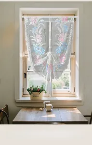 Detail of white lace tie-up curtain with lily floral embroidery and scalloped edges