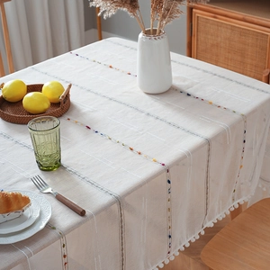 Nordic minimalist cream tablecloth with colorful embroidery and pom-pom trim decor