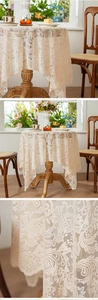 Macro-opname van Frans kanten tafelkleed met vintage rozenpatronen en opengewerkte details