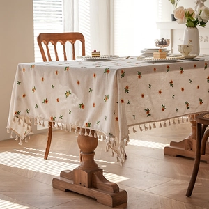 Embroidered beige cotton linen tablecloth with yellow floral patterns and tassels