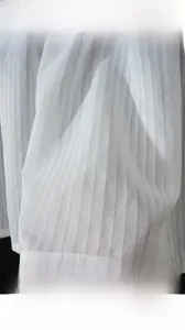 Macro shot of white pleated fabric detail with silky texture and blackout light blocking