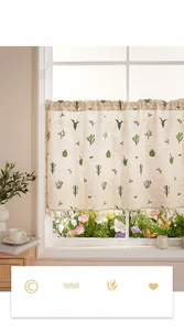 Close-up of beige linen cafe curtain with cactus prints and elegant tassel fringe details