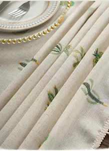 Detail of embroidered cactus pattern on thick linen tablecloth with fine stitching