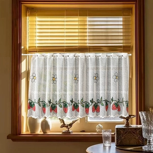 Rustic white lace cafe curtain with embroidered strawberries and flowers on a rod