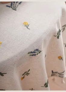 Macro detail of pastoral floral embroidery on thick linen tablecloth with floral patterns