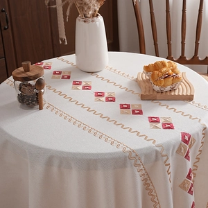 Round cream tablecloth with geometric embroidery for dining tables in home setting