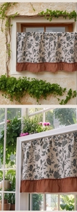 Detail of floral cafe curtain with terracotta ruffled edges and cotton linen texture