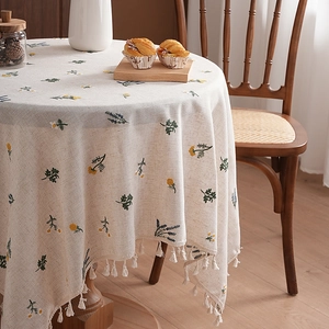 Pastoral round linen tablecloth with yellow floral patterns and white fringe edges