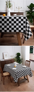 Close-up of black and white checkerboard tablecloth with elegant tassel fringe edges
