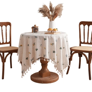 Floral embroidered linen round tablecloth with tassels in rustic Nordic country style