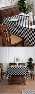 Close-up of black and white checkered tablecloth texture with elegant fabric drape