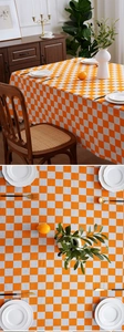 Detailed macro view of orange and grey checkered linen tablecloth with clean edge texture