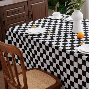 Classic black and white checkered rectangular tablecloth in a modern Nordic dining setting