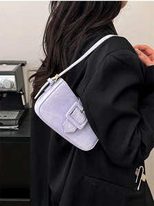 Detailed side view of lavender suede baguette bag with a large square buckle and gold hardware