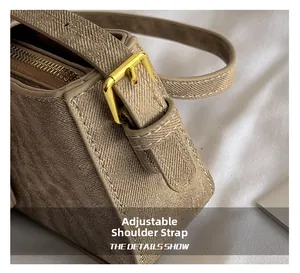 Detail of adjustable beige jacquard strap with golden buckle for retro baguette bag