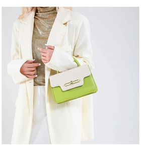 Detail of lime green and off-white shoulder bag with elegant gold rectangle metal lock