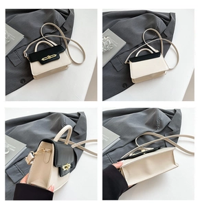 Detailed views of a minimalist cream and black crossbody bag with metal clasp and strap