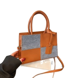 Borsa a mano retrò color-block in pelle arancione e tessuto grigio con design patchwork