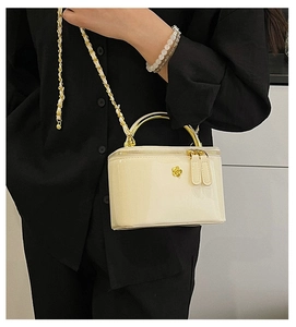 Chic cream patent leather box bag with gold floral ornament and metal handle