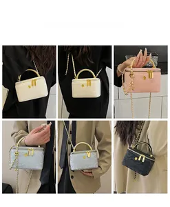 Detailed views of mini chain box bags in white pink and blue with gold handles