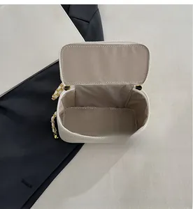 Macro shot of white quilted cosmetic bag showing spacious interior with chevron lining