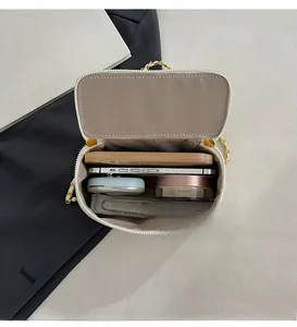Detailed interior of quilted chain bag showing space for phone, makeup, and power bank