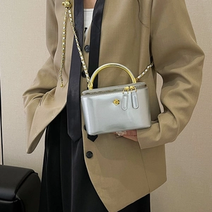 Silver metallic chain bag with golden camellia flower accent and metal handle