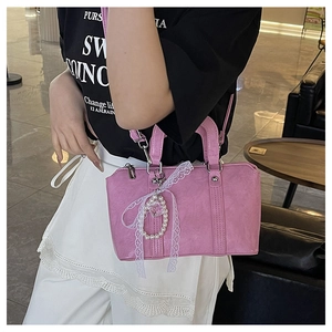 Pink bow handbag featuring white lace detail and a heart pearl pendant accessory