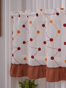 Detailed embroidery on white semi-transparent cafe curtain with brown pleated trim