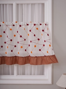Detail of white cafe curtain with geometric embroidery and brown satin ruffle trim