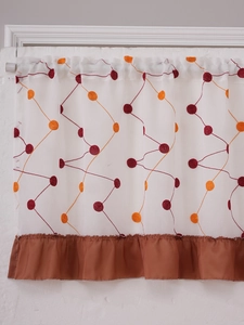 Detail of white cafe curtain with orange embroidery dots and brown satin ruffle trim
